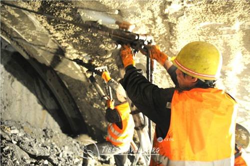 a worker works in guanjiao-tunnel