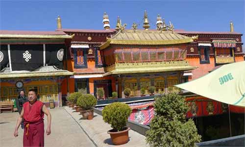 An ornate monastery on the side of a mountain in Tibet Autonomous Region. 