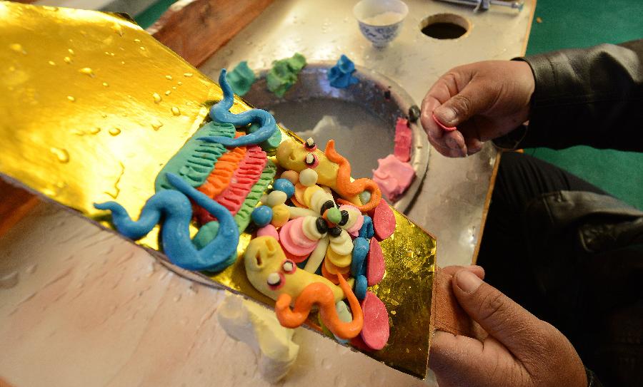 A craftsman makes a butter sculpture