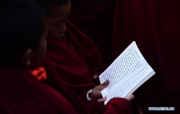 Two young Tibetan Buddhist monks chant mantras