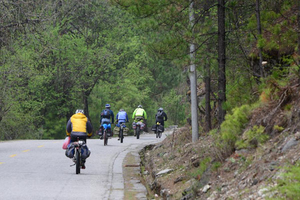 a few cyclists on the Pome section of Sichuan-Tibet Highway