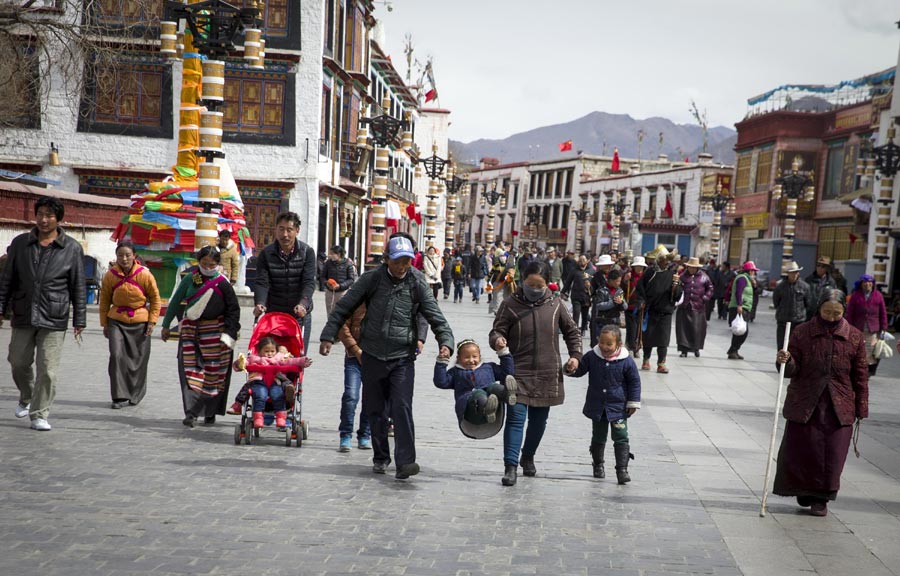 Tibet local twins  on the revamped Barkor Street with their parents