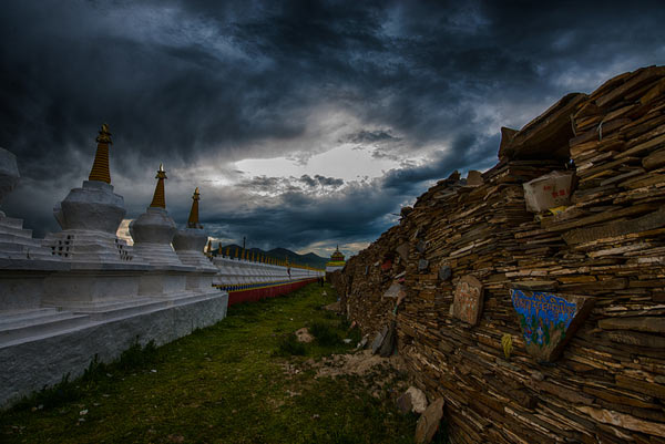 the Bage Mani Stone Wall consists of rows of piled-up Mani stones, engraved or painted with Tibetan Buddhism sayings
