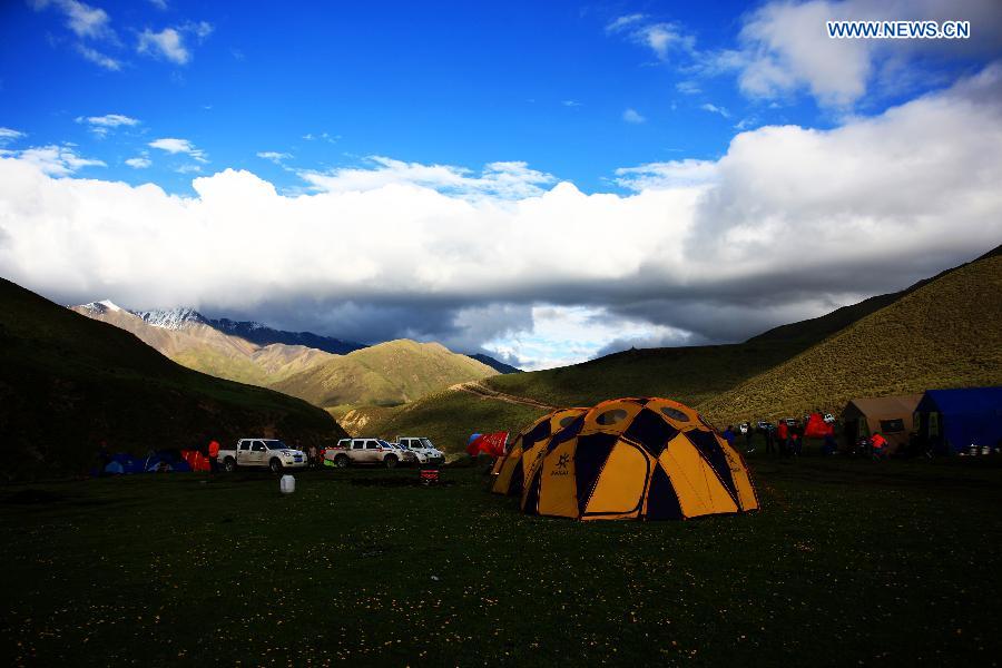Expedition members have a rest at a camp on the mountainous area