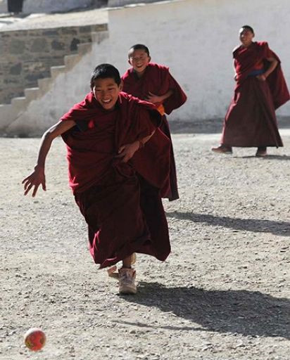Young monks are playing football