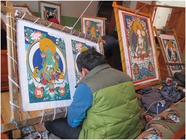 Thangkas paintings depict Buddhist life on cotton or silk applique