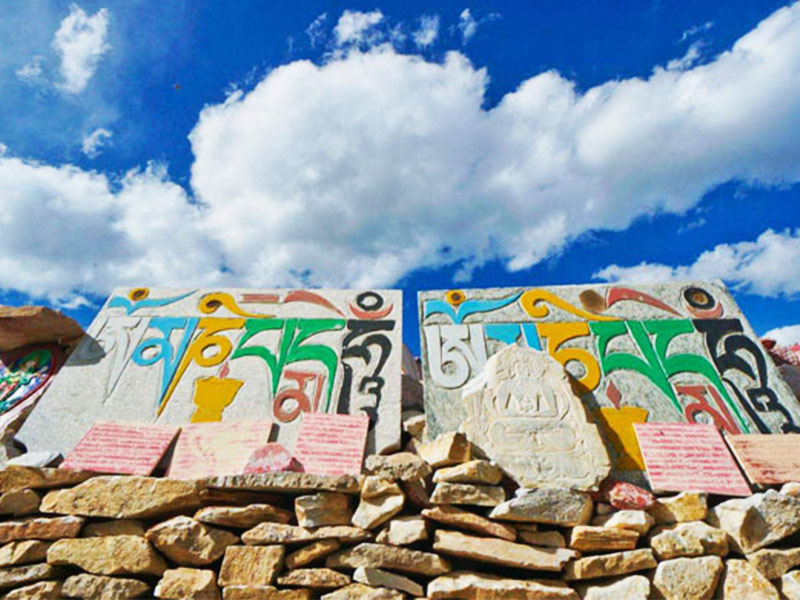 These are stones carved and colourfully painted with Buddhist scripts