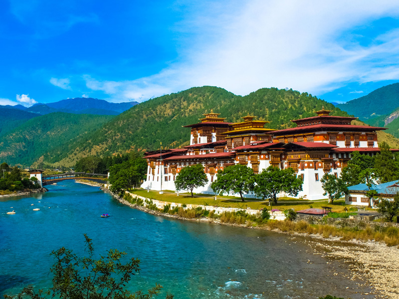 Punakha Dzong,together with the mountains, the fast flowing river and the blue sky makes a good picture.