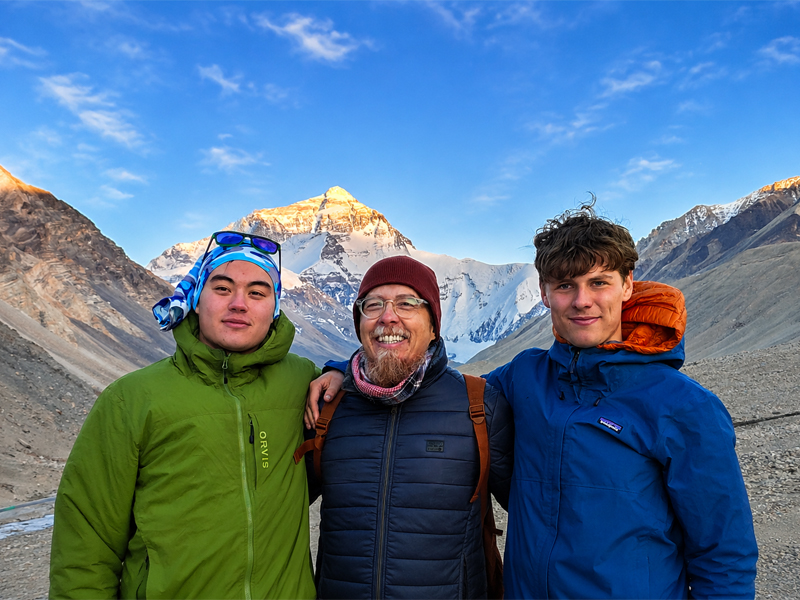 Everest Base Camp Tour with Local Tibetan Guide Guests with a local Tibetan guide at Everest Base Camp, Tibet, with Mount Everest in the background