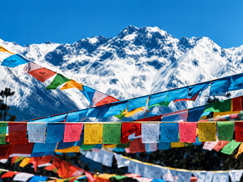 Tibetan Prayer Flags against Snow-Capped Mountains Colorful Tibetan prayer flags with snow mountains in the background