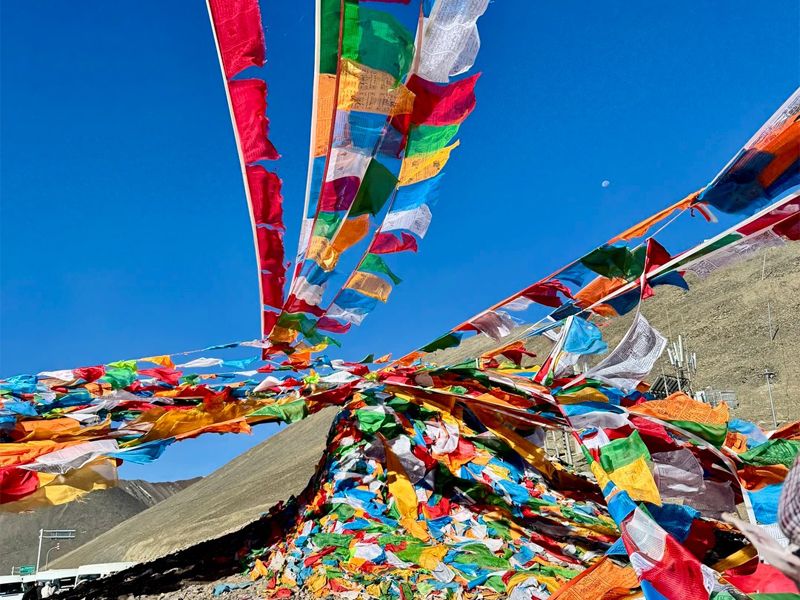 Prayer Flags on a High Mountain Pass in Tibet Tibetan prayer flags hanging high on a mountain pass
