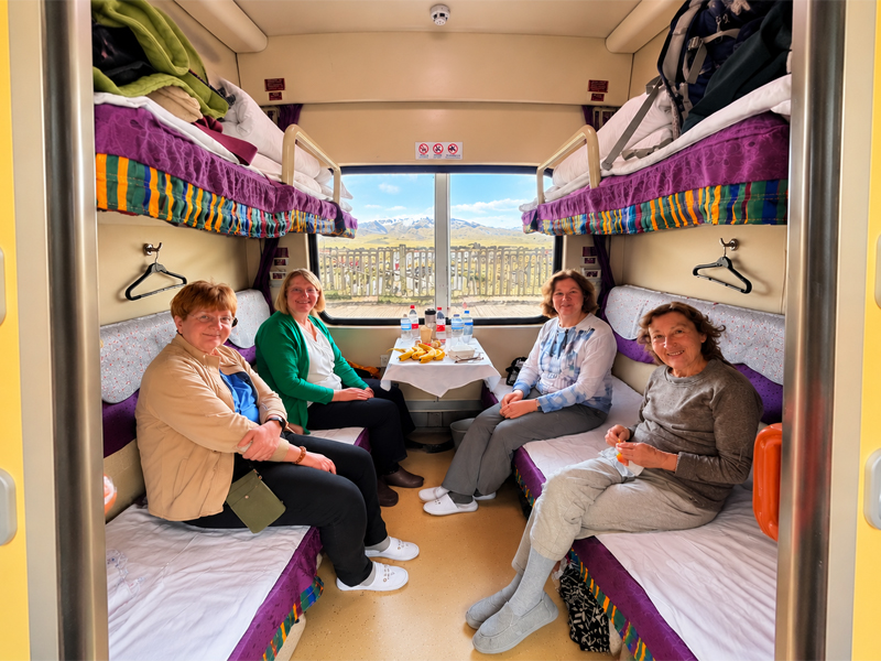 Tibet train soft sleeper cabin with four berths Four travelers relaxing in a Tibet train soft sleeper cabin