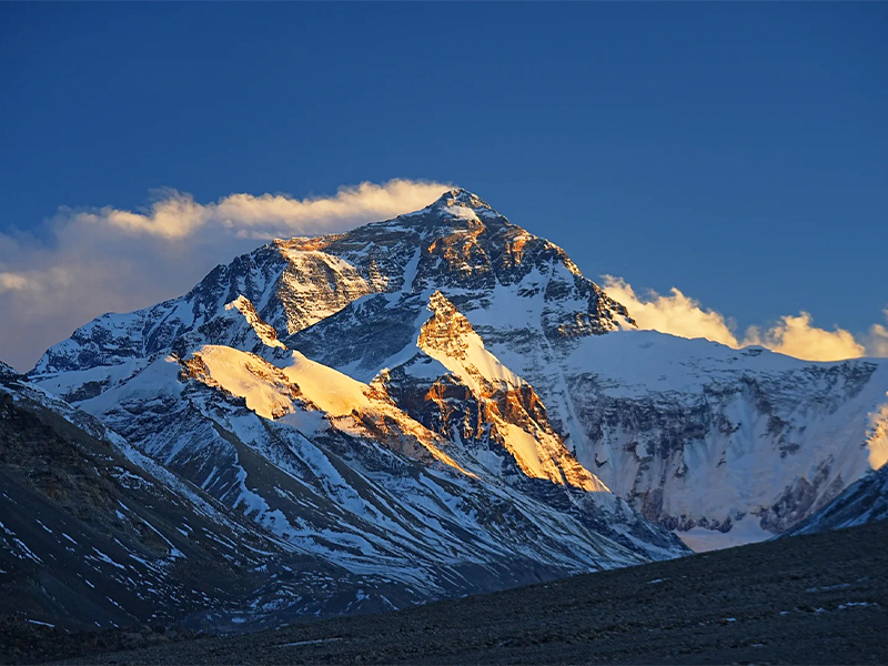 Golden Sunrise over Mount Everest in Winter Golden sunrise illuminating the snow-covered Mount Everest in winter